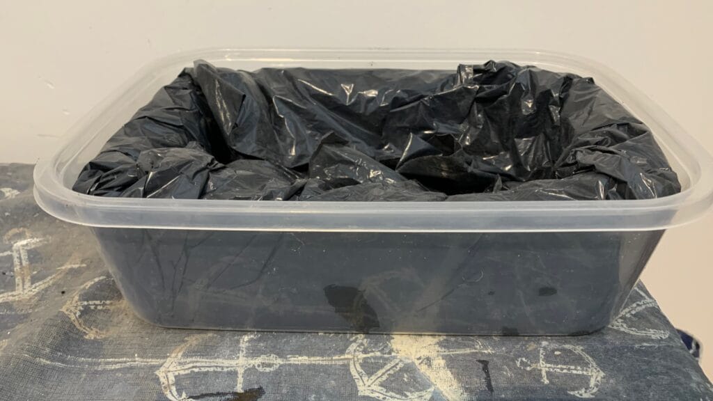 A hypertufa pot resting in the mold for 24 hours before unmolding and finishing